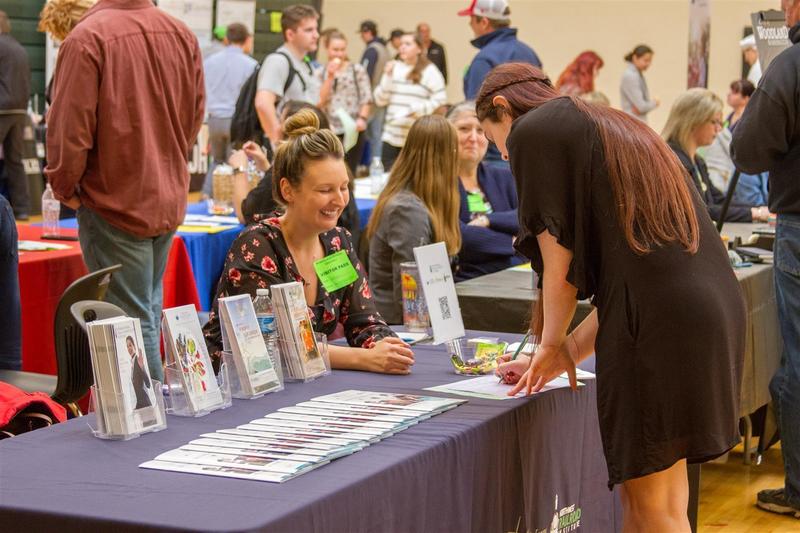 Students visited businesses at their tables and interviewed them about the qualifications required to get a job with the company Students visited businesses at their tables and interviewed them about the qualifications required to get a job with the company